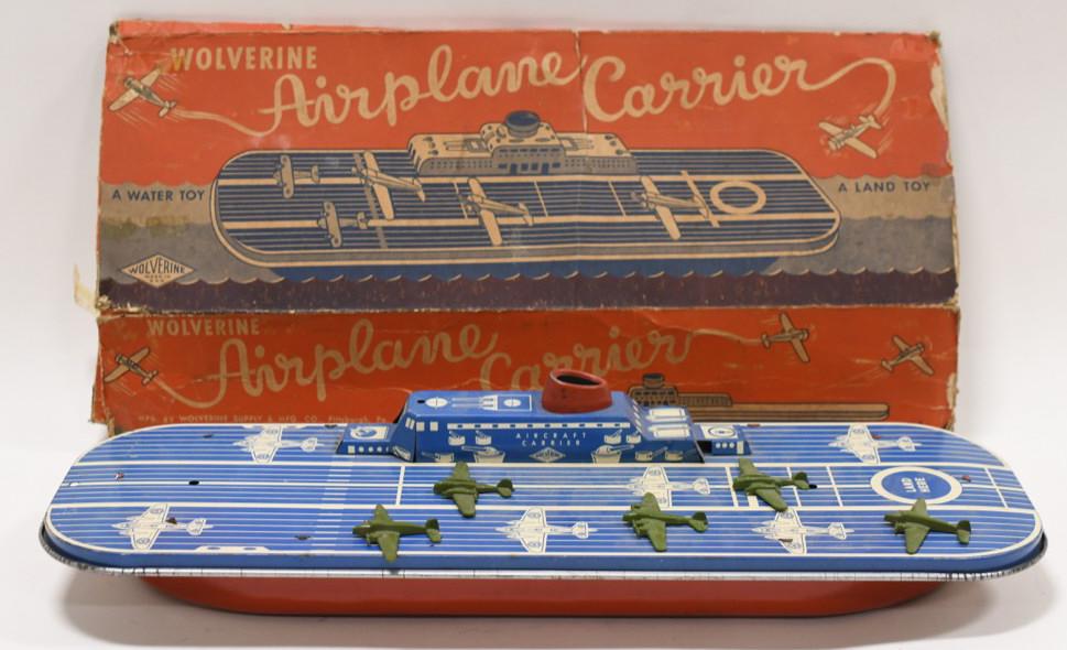 Wolverine Tin Litho Aircraft Carrier: Nice Wolverinr tin litho aircraft carrier. Displays nicely with light wear from play and age. Comes with the original box. Box is in rough condition. The planes on the carrier are plastic. Measures ap