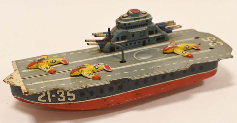 Japan Tin Litho 21-35 Aircraft Carrier Windup: Nice Japan tin litho 21-35 aircraft carrier. Displays nicely light wear from play and age. Toy has light surface rust. Working condition Measures approximately 10 1/2" long.