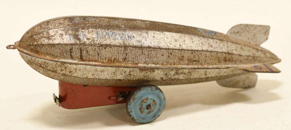 Tin Graff Zeppelin Pull Toy: Nice pressed steel tin Graf Zeppelin pull toy. Displays nicely with wear from age and play. Measures approximately 9" long.