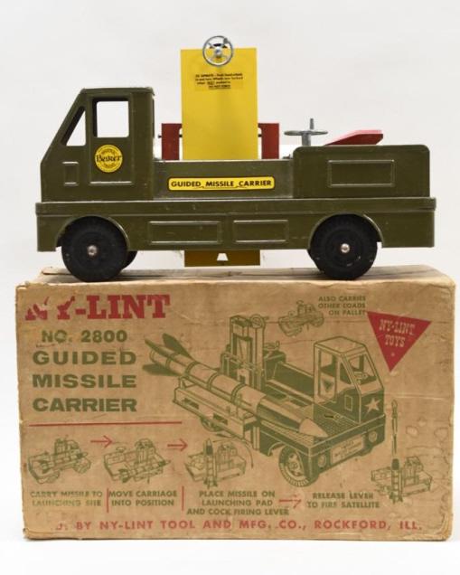Ny-Lint No.2800 Guided Missile Carrier: Nice Ny-Lint no. 2800 guided missile carrier comes with the original box. Toy is in nice condition ith paint loss and wear from play and age. Box is missing a flap, has tape, and has staining. Measure