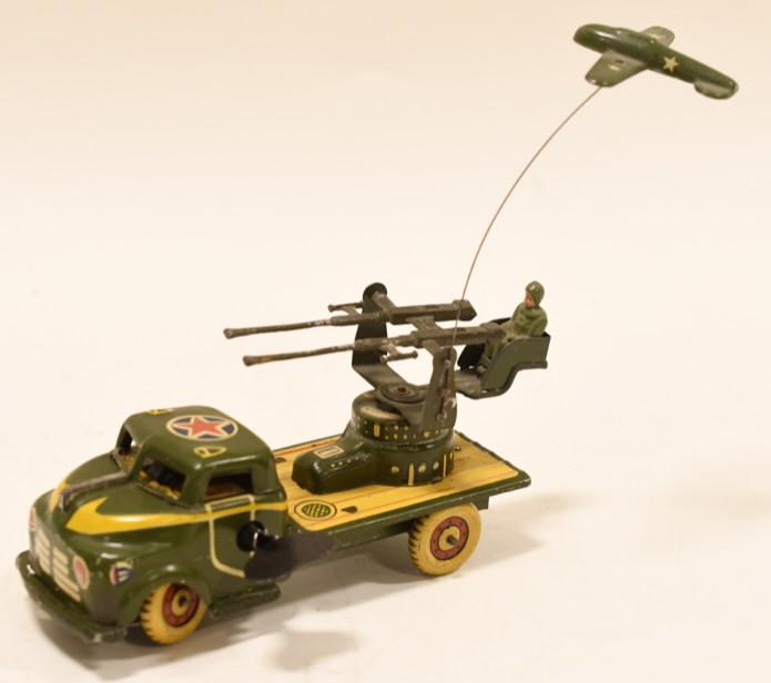 Tin Litho Windup Army Truck W/ Plane & Gun: Nice tin litho windup Army Truck with plane and gun. Displays nicely with wear from play and age. Windup works, but isn't strong. Measures approximately 5 1/2" long.