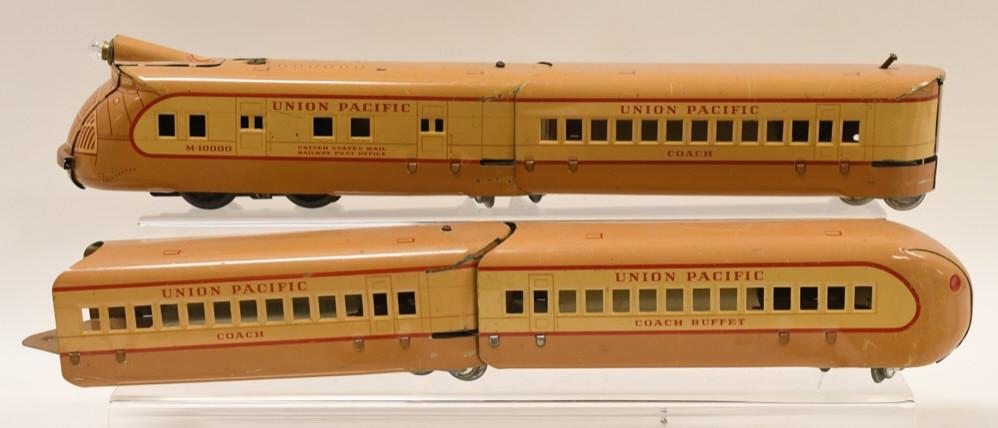 Marx Union Pacific M-10000 Streamliner Train Set: Nice Marx Union Pacific M-10000 streamliner train set. Includes a Marx M-10000 engine, 2 Marx coaches, and a Marx Coach buffet. Set displays nicely with paint loss and wear from play and age.