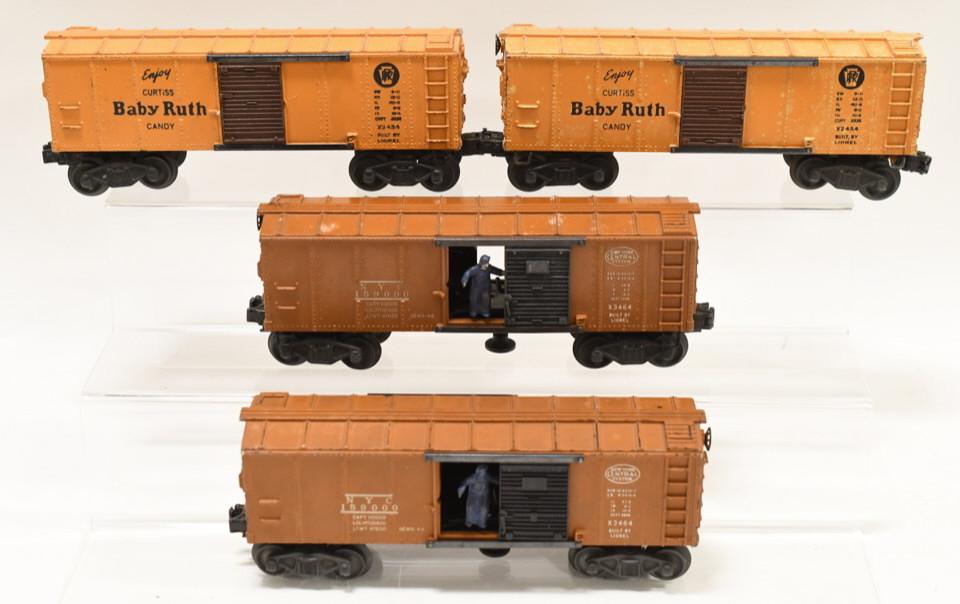 Lot of Postwar Lionel O Gauge Box Cars: Nice lot of Lionel O Gauge Box Cars. Includes Lionel (2) #X2454 Baby Ruth and (2) #X3464 New York Central System box cars. All display nicely with wear from play and age.