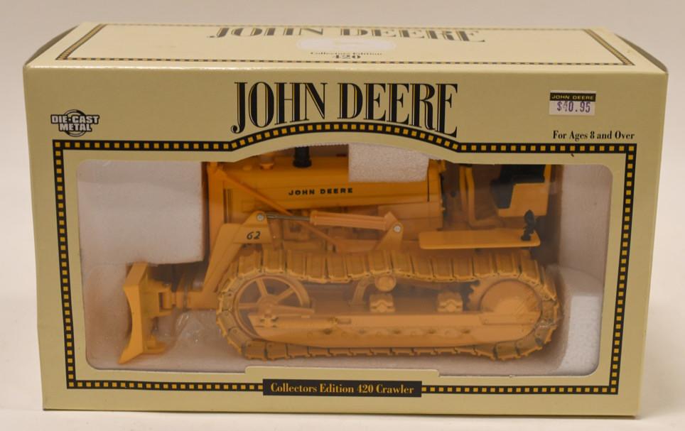 1/16 Ertl John Deere 420 Crawler with Blade: Nice 1/16 scale die-cast John Deere 420 crawler with blade in box. Displays nicely with light wear from storage and age.