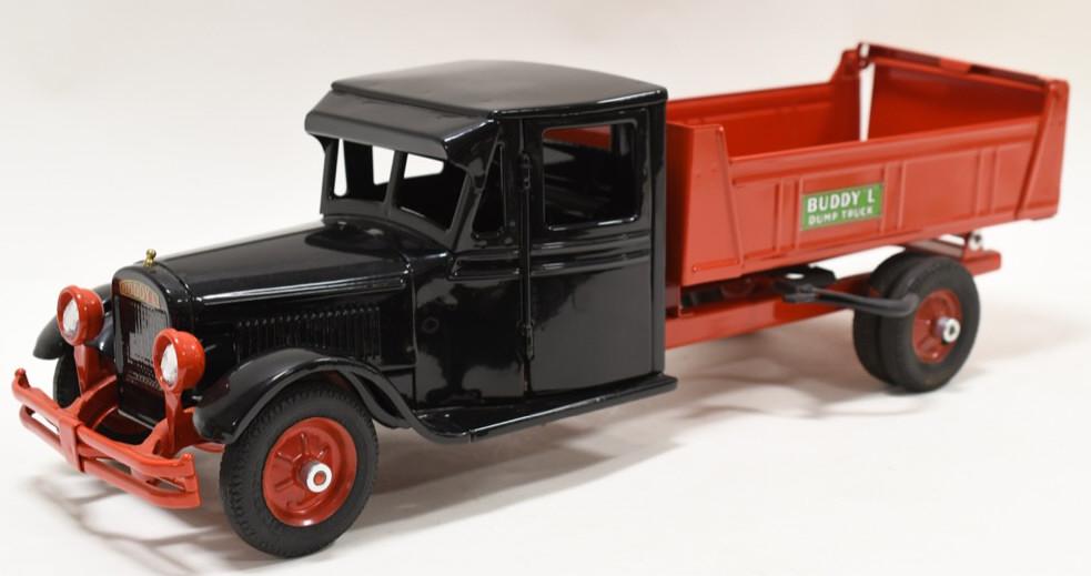 Restored Buddy L Junior Dump Truck: Very nice restored Buddy L Junior Dump Truck. Nice professional restoration. Has light wear from display and age. Displays nicely. Measures approximately 24" long.
