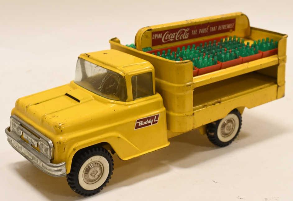 Buddy L Coca Cola Delivery Truck: Nice original Buddy L Coca Cola delivery truck. Has paint loss and wear from age and play. Comes with some Coca Cola bottles. Measures approximately 15" long.