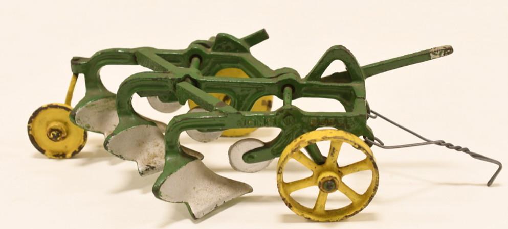 Early Cast Iron Vindex John Deere 3 Bottom Plow: Nice early cast iron Vindex John Deere 3 bottom plow. Has an older paint restoration. "John Deere" is embossed on the plow. Displays nicely with wear from play and age. Measures approximately 9" long.