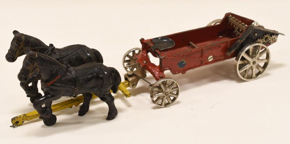 Cast Iron Arcade McCormick-Deering Manure Spreader: Nice original early cast iron Arcade McCormick-Deering manure spreader with team of horses. Displays nicely with paint loss and wear from play and age. Measures approximately 14 1/2" long.