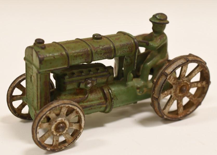 Cast Iron Arcade Fordson Tractor: Nice vintage cast iron Arcade Fordson tractor. Nice condition with some paint loss and wear from use and age. Displays very well with with a great look. It measures approximately 5" across.