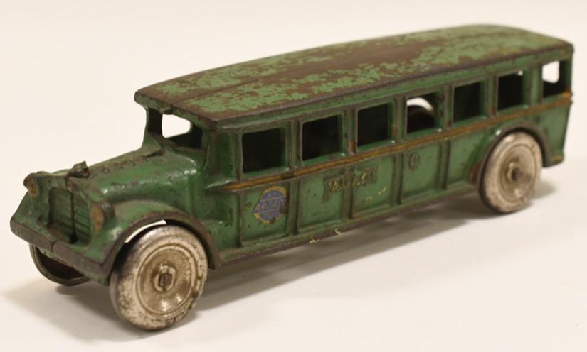 Early Cast Iron Arcade Fageol Safety Coach Bus: Nice cast iron Arcade Fageol Safety Coach bus. Has paint loss and wear from play and age. Has the Arcade decal. Embossed Arcade MFG. Co. on the inside. Measures approximately 8 inches long.