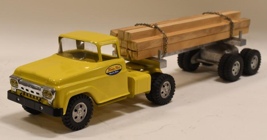 Restored Tonka Log Hauler Truck & Trailer: Nice professionally restored Tonka Log Hauler truck and trailer. Nice condition with light wear from display. Displays very nicely. Measures approximately 23 1/2" long overall.