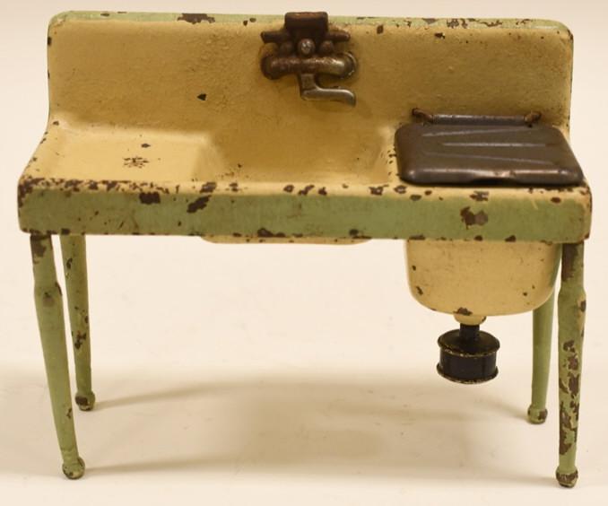 Early Cast Iron Arcade Kitchen Sink: Nice early cast iron Arcade Kitchen Sink. Displays nicely with paint loss and wear from play and age. Has the arcade decal on it. Measures approximately 5 3/4" long.