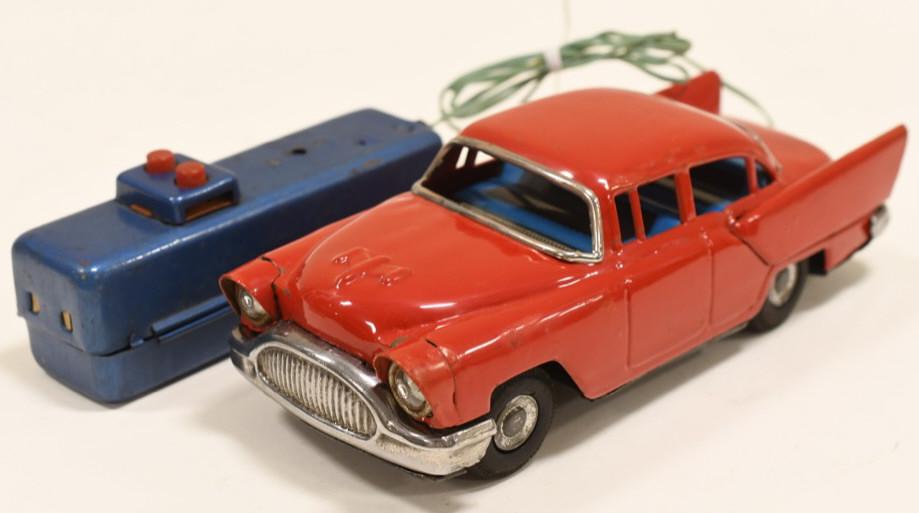 Japan Tin Battery Op. 1957 Oldsmobile Car: Nice tin battery operated remote control 1957 oldsmobile car. Nice working condition. Has some aint loss and wear from play and age. Measures approximately 8 1/2" long.