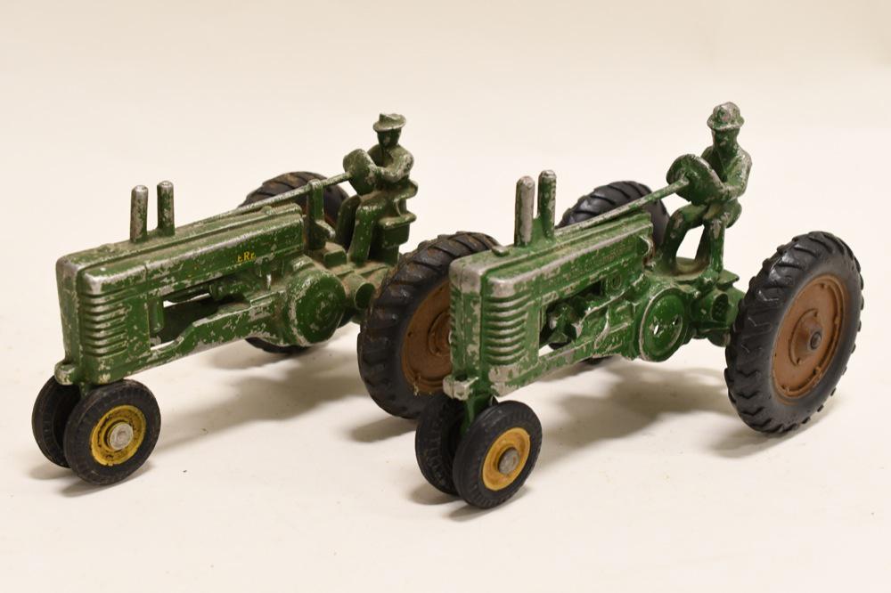 (2) Vintage 1/16 Scale John Deere Model A w/ Man: Nice lot of 2 vintage 1/16 scale John Deere Model A's with men. Both have paint loss and wear from play and age. Nice vintage toys.