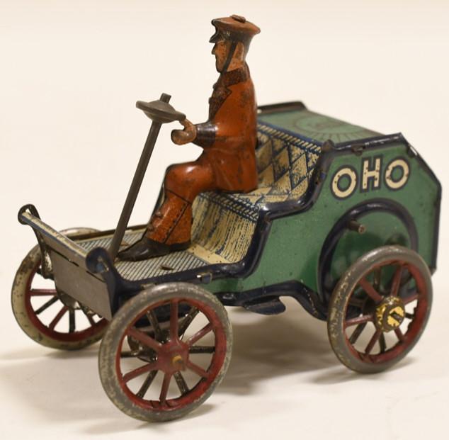 Tin Windup Lehmann OHO Man Driving Early Car: Nice scarce tin windup Lehmann OHO man driving early car. Displays nicely with paint loss and wear from play and age. Windup needs work. Measures approximately 4" long.