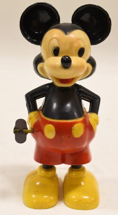 Marx Windup Mickey Mouse w/ Twirling Tail: Nice vintage Marx windup Mickey Mouse with twirling tail. Has paint loss and wear from play and age. Windup works but needs help to get it started. Measures approximately 6 1/2" tall.
