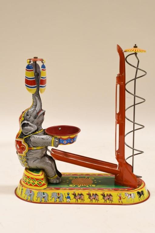 JW West Germany Tin Litho Windup Circus Elephant: Nice JW Western Germany tin litho windup circus elephant. Missing the key for the windup. Missing the balls. Displays nicely with wear from age and play. Measures approximately 10" tall.