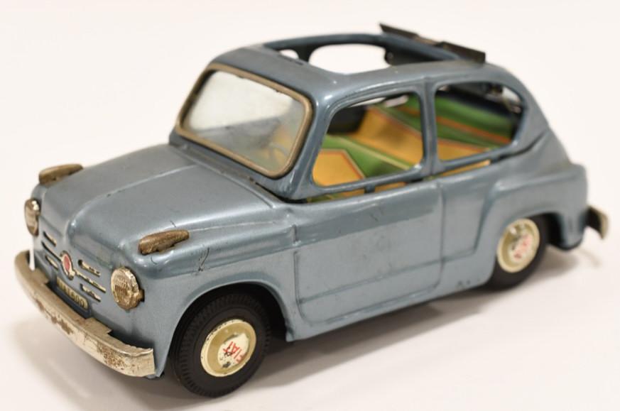 Bandai Japan Tin Litho Fiat 600 w/ Sun Roof: Nice Bandai Japan tin litho Fiat 600 with retractable roof. Displays nicely with paint loss and wear from play and age. Measures approximately 7" long.