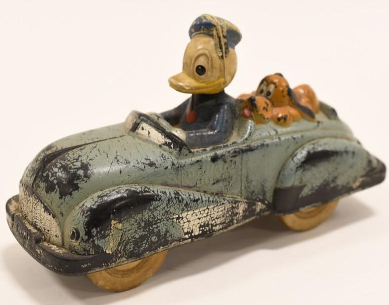 Auburn Rubber Donald Duck & Pluto Car: Nice vintage Auburn Rubber Donald Duck and Pluto Car. Displays nicely with some paint loss and wear from play and age. Measures approximately 6 1/2" long.