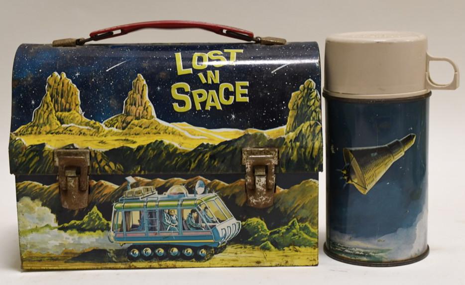 1967 Thermos Lost in Space Metal Lunch Box: Nice 1967 Thermos Red Barn metal lunch box with thermos. Lunch box has paint loss and wear from use and age. Missing the piece to hold the thermos. Displays nicely. Measures approximately 9" across.