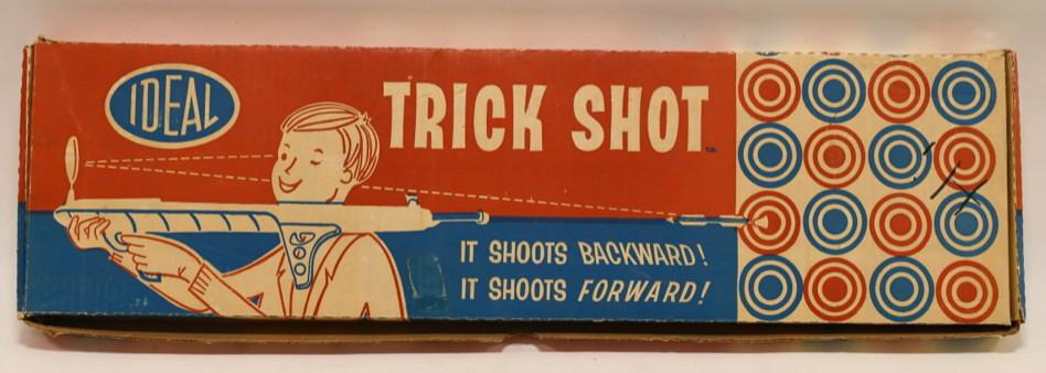 1961 Ideal Toys Trick Shot Gun: Nice Ideal Toys trick shot gun in the original box. Box has the original liner insert. Displays nicely with light wear from age. Measures approximately 28" across.