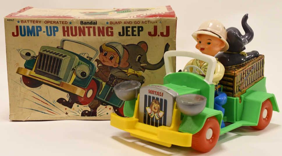 Bandai Battery Op. Jump-Up Hunting Jeep J.J: Nice Bandai battery operated jump-up hunting jeep J.J with box. Displays nicely with wear from age and play. Toy is untested. Measures approximately 12" across.