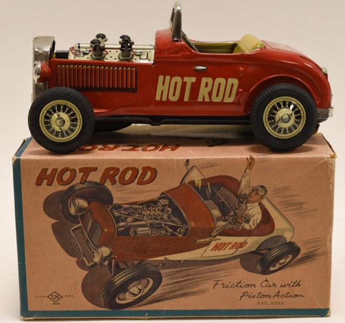 T.N Japan Tin Friction Hot Rod Car: Nice tin friction T.N Japan hot rod car with piston action. Pistons move up and down when car is pushed. Displays nicely with wear from play and age. Comes with box. Measures approximatley 7" long.