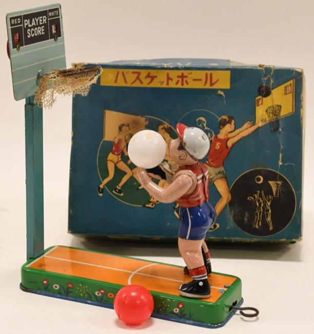 ATC Japan Tin Lever Action Basketball Player: Nice tin litho ATC Japan baskeball player with box. Comes with a red and white ball. Pull the lever and it shoots the ball. Players are able to keep score with the backboard. Displays nicely with wear
