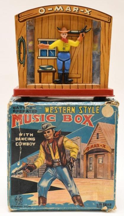 Linemar Western Style Music Box w/ Dancing Cowboy: Nice tin battery op. Linemar western style music box with dancing cowboy in box. Displays nicely with wear from play and age. Untested, but battery compartment is clean. Measuers approximately 5" tall