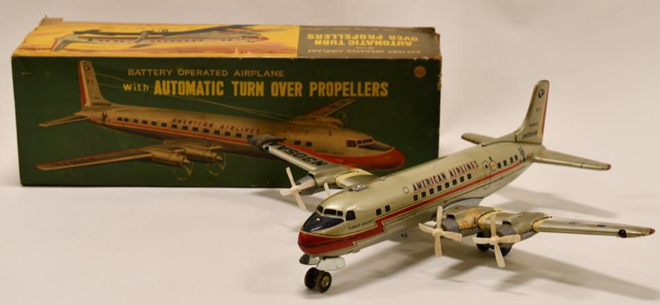 Linemar Battery Op American Airlines DC-7 Airplane: Nice tin battery operated Linemar American Airlines DC-7 Airplane with box. Displays nicely with some dents and dings from play and age. Wingspan measures approximately 20" long.