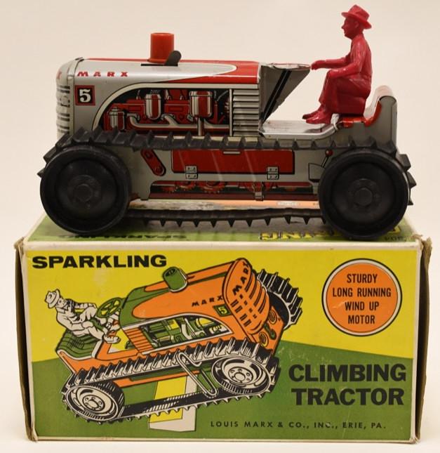 Marx Tin Windup Sparkling Climbing Tractor: Nice Marx tin windup Sparkling climbing tractor. One of the tracks needs to be put back on. Displays nicely with wear from play and age. Measures approximately 8 1/2" long.