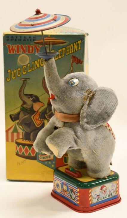 T.N Japan Battery Op. Windy Juggling Elephant: Nice T.N Japan battery operated windy juggling elephant with box. Displays nicely with some wear from age and play. Elephant has some staining. Measures approximately 10" tall.