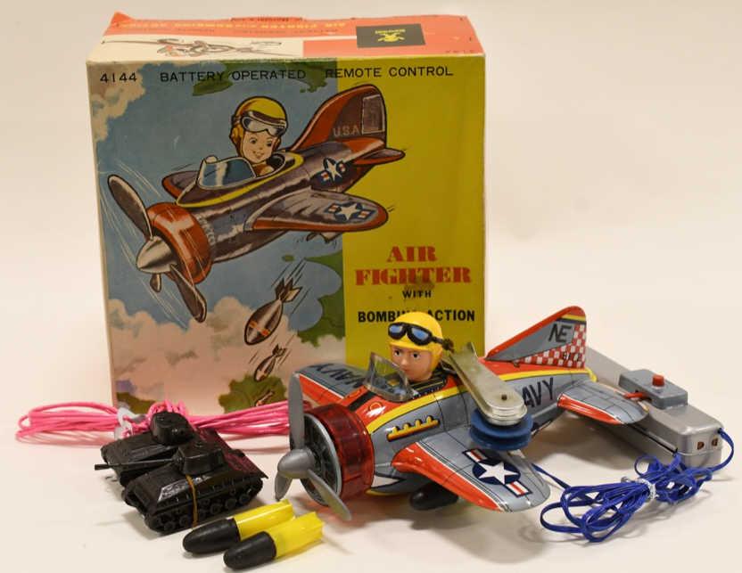 Bandai Tin Battery Op Air Fighter w Bombing Action: Nice Bandai tin battery operated Air Fighter with bombing action in box. Displays nicely with some wear from play and age. Untested. Measures approximately 9" long.
