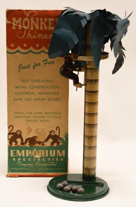 Emporium Tin Monkey Shines Climbing Monkey: Nice tin Emporium specialties co. Monkey Shines in box. Box has wear and tear. It is missing the top flaps. Displays nicely with some wear from play and age. Measures approximately 18" tall.