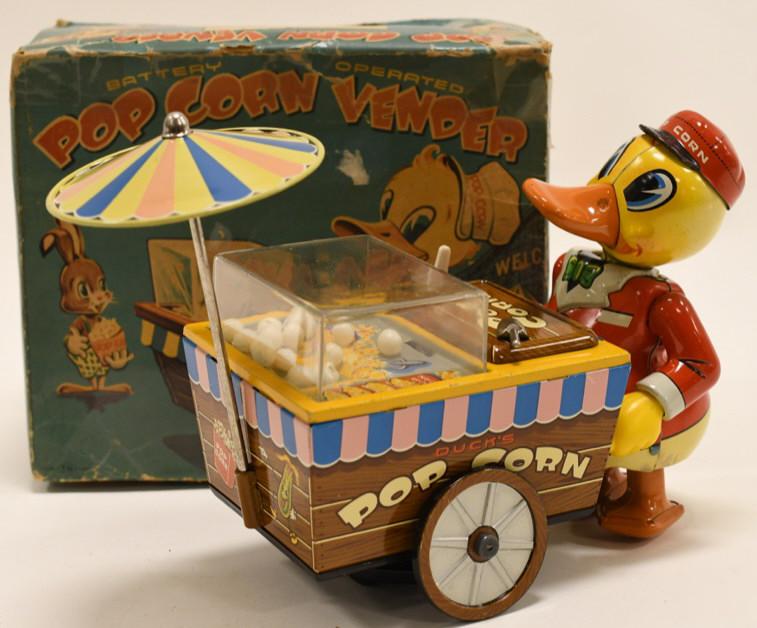 T.N Japan Tin Battery Op. Pop Corn Vendor Duck: Nice T.N Japan tin battery operated pop corn vender duck with box. Box has tape repairs and wear from age. Duck displays nicely with some wear from play and age. Untested. Measures approximately 8" lo