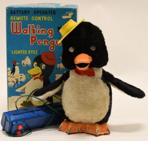 Modern Toys Battery Op. Walking Penguin: Nice Modern Toys battery operated remote control Walking Penguin in reproduction box. Displays nicely with wear from age and play. Untested. Measures approximately 9 1/2" tall.