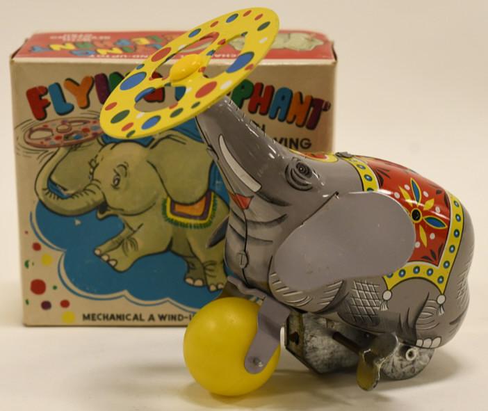 Yone Tin Windup Flying Elephant w/ Revolving Gyro: Nice Yone tin windup fllying elephant with revolving gyro with box. Displays nicely with wear from age and play. Nice condition. Measure approximately 5" long.
