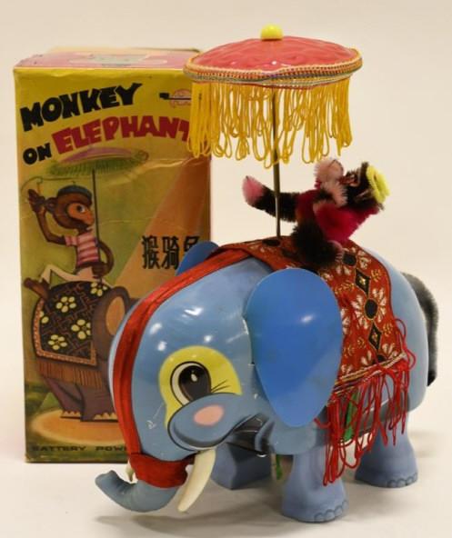 Vintage Tin Battery Op. Monkey on Elephant: Nice tin and pastic battery operated monkey on elephant with box. Displays nicely with some wear from age and play. It looks like one of the elephant tusks melted. Measures approximately 9 3/4" tall.
