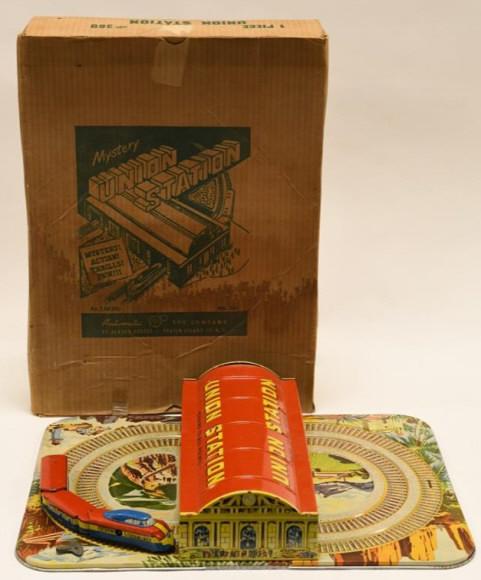 Automatic Toy Co. Tin Mystery Union Train Station: Nice Automatic Toy Co. tin windup Mystery Union Train Station with box. Box has some wear from age and display. Windup mechanism works, but when you put the train on the track it doesn't go. Station d
