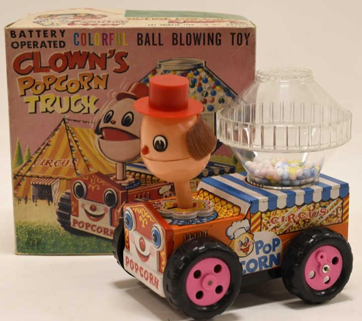 T.P.S Tin Battery Op. Clown's Popcorn Truck: Nice tin battery operated clown's popcorn truck with box. Nice colorful ball blowing toy. Displays nicely with some wear from play and age. Measures approximately 6" long.