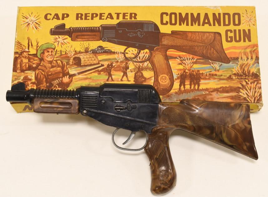 Marx Cap Repeater Commando Gun: Nice Marx cap repeater commando gun with box. Displays nicely with light wear from age. Made of mostly plastic. Measures approximately 12 1/2" across.