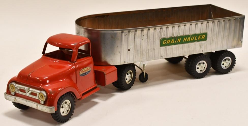 Tonka Grain Hauler Truck with Trailer: Nice Tonka Grain Hauler round fender truck with trailer. The truck and trailer have paint loss and wear from play and age. Displays nicely. Overall measures approximatley 23 1/2" long.
