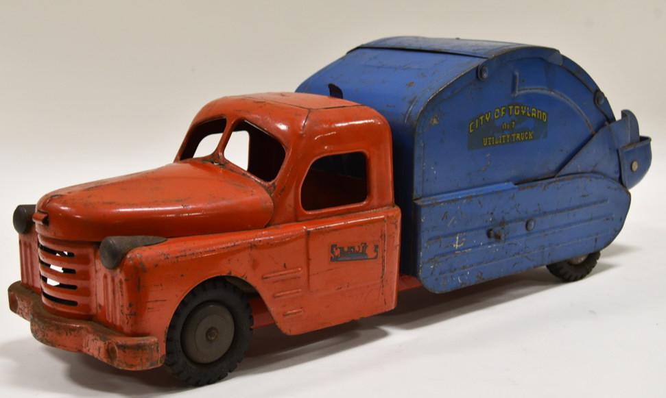 Structo City of Toyland No 7 Utility Garbage Truck: Nice Structo City of Toyland No. 7 utility garbage truck. The truck has the engine under the hood. The crank works. Displays nicely with paint loss and wear from play and age. Measures approximately 2