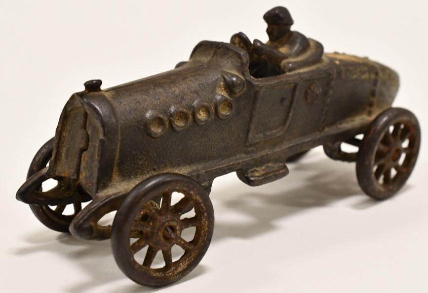 Cast Iron Boat Tail Racer: Cast iron boat tail racer car. Displays nicely with wear from storage and display. Measures approximately 5 1/4" long.