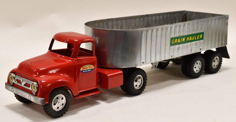 Tonka Grain Hauler Truck and Trailer: Restored Tonka grain hauler truck and trailer. Nice condition with some wear from storage and display. Overall measures approximately 23 1/2" long.
