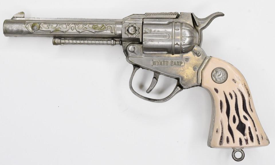 Actoy Wyatt Earp Cap Gun Pistol: Actoy Wyatt Earp cap gun pistol. Pistol displays nicely with some wear from play and age. The trigger works. Measures approximately 8 3/4" long.