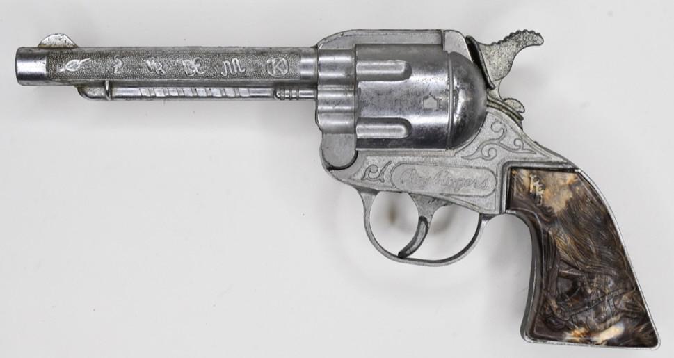 Kilgore Roy Rogers Cap Gun Pistol: Kilgore Roy Rogers cap gun pistol. Pistol displays nicely with some wear from play and age. Trigger the horse is featured on the grips. The gun trigger needs some work. Measures approximately 9" long.