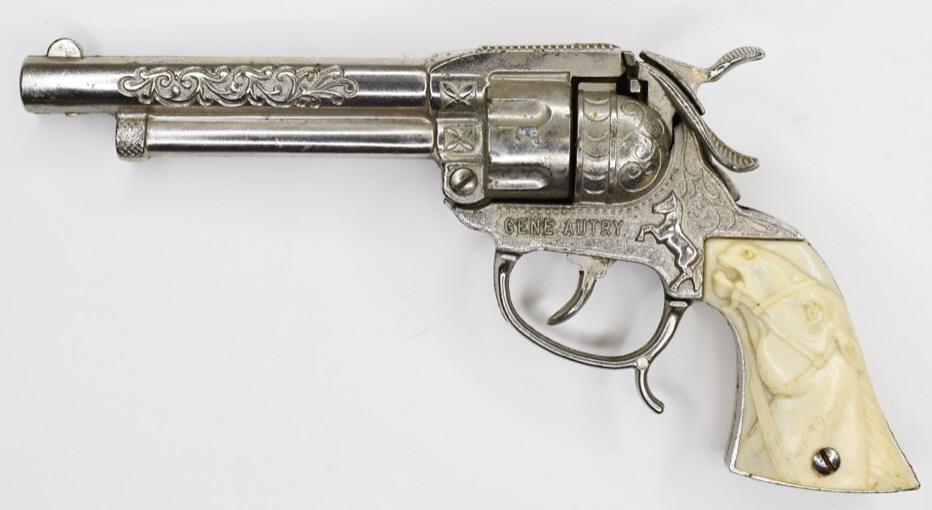 Leslie-Henry Gene Autry Cap Gun Pistol: Gene Autry cap gun pistol by Leslie-Henry. Pistol displays nicely with some wear from play and age. Champion the horse is featured on the grips. The gun trigger works. Measures approximately 8 1/2" lo