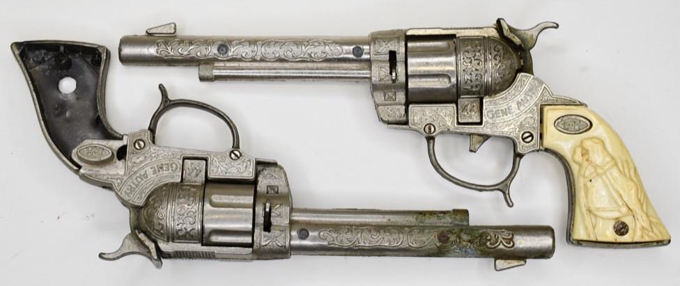 (2) Leslie Henry .44 Gene Autry Cap Gun Parts: Pair of Leslie Henry .44 Gene Autry cap gun pistols for parts. The one has the grips, but they are cracked and the trigger is broken. The other gun is missing the trigger and the grips. Measures appro