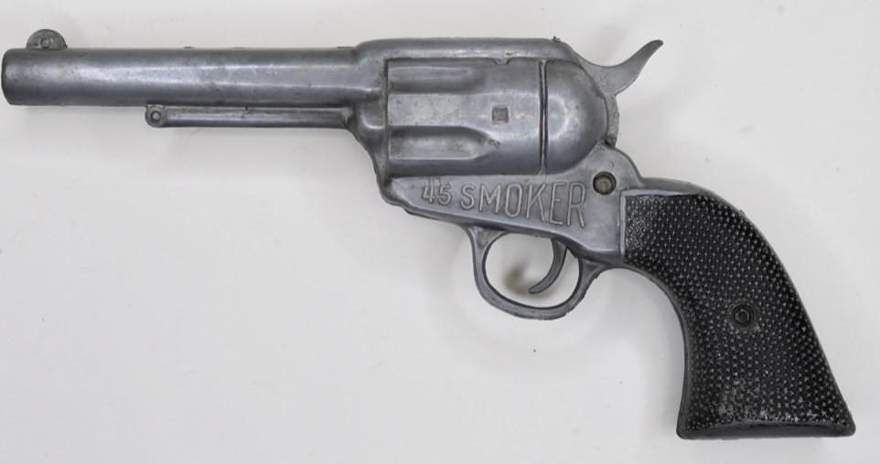 PECO 45 Smoker Toy Gun: 1950's 45 SMOKER by Product Eng. Co. Portland Oregon. Insert pistol into bag of powder, cock hammer, add cap, fire! Smoke-like powder comes from gun. All metal with black painted grips. Not tested but